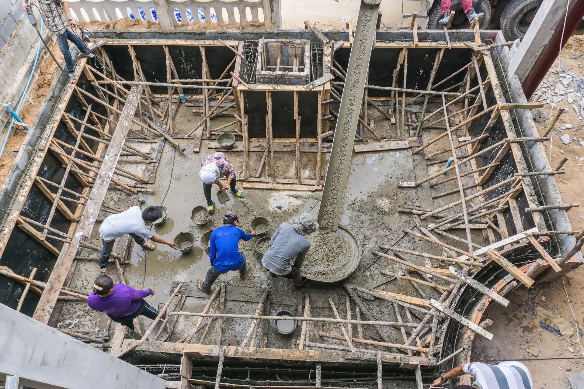 An aerial shot of the complete framing for a pool and the beginnings of a gunite pour.